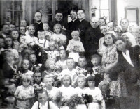 Przed plebanią w Lipowcu, widać istniejący stary drewniany ganek. Wśród księży ówczesny proboszcz ks. Niebrzydowski (3 od prawej) oraz rekolekcjonista. Rok ok. 1962